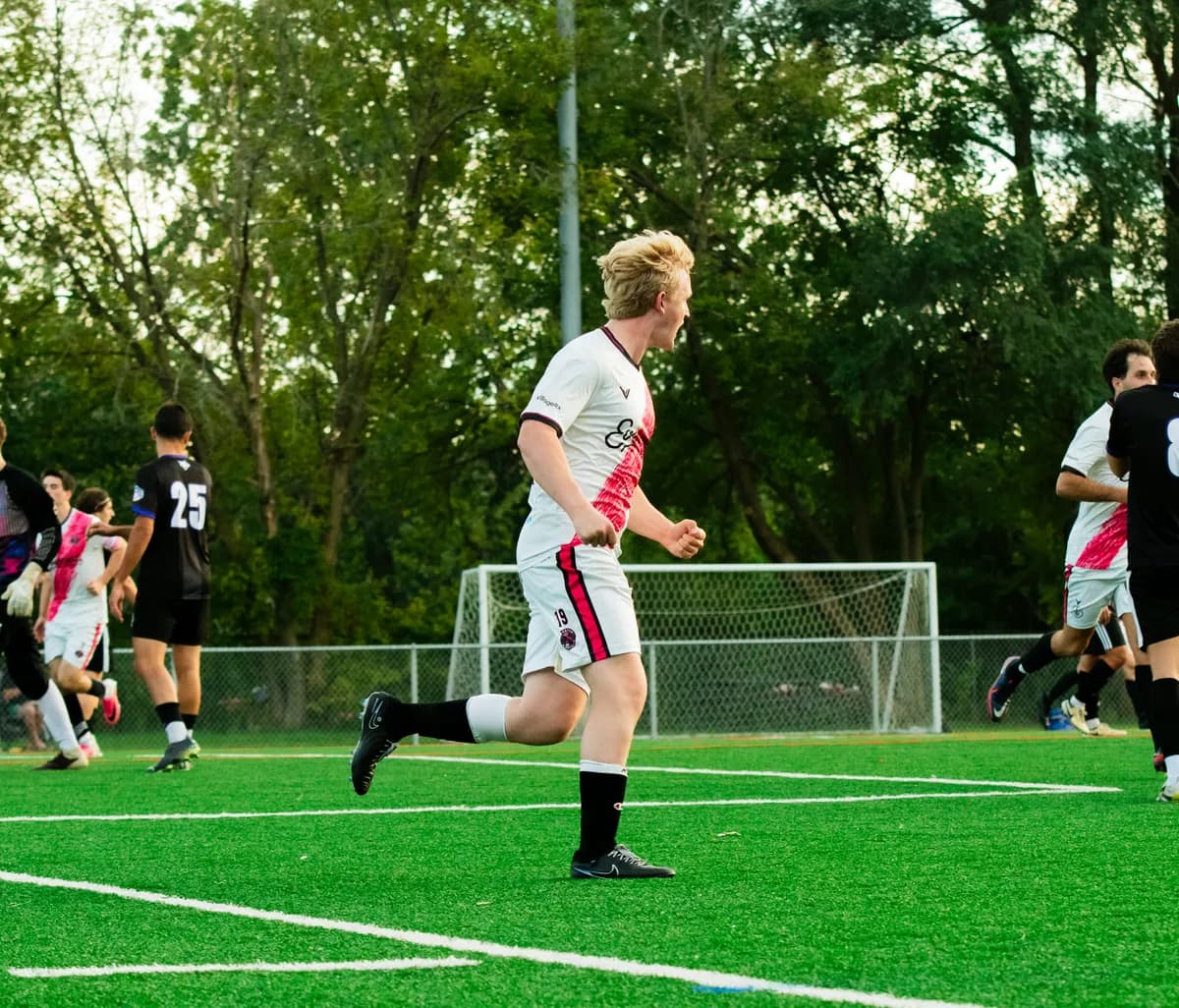 A Wheaton Wanderers player celebrates on the pitch at Camera Park